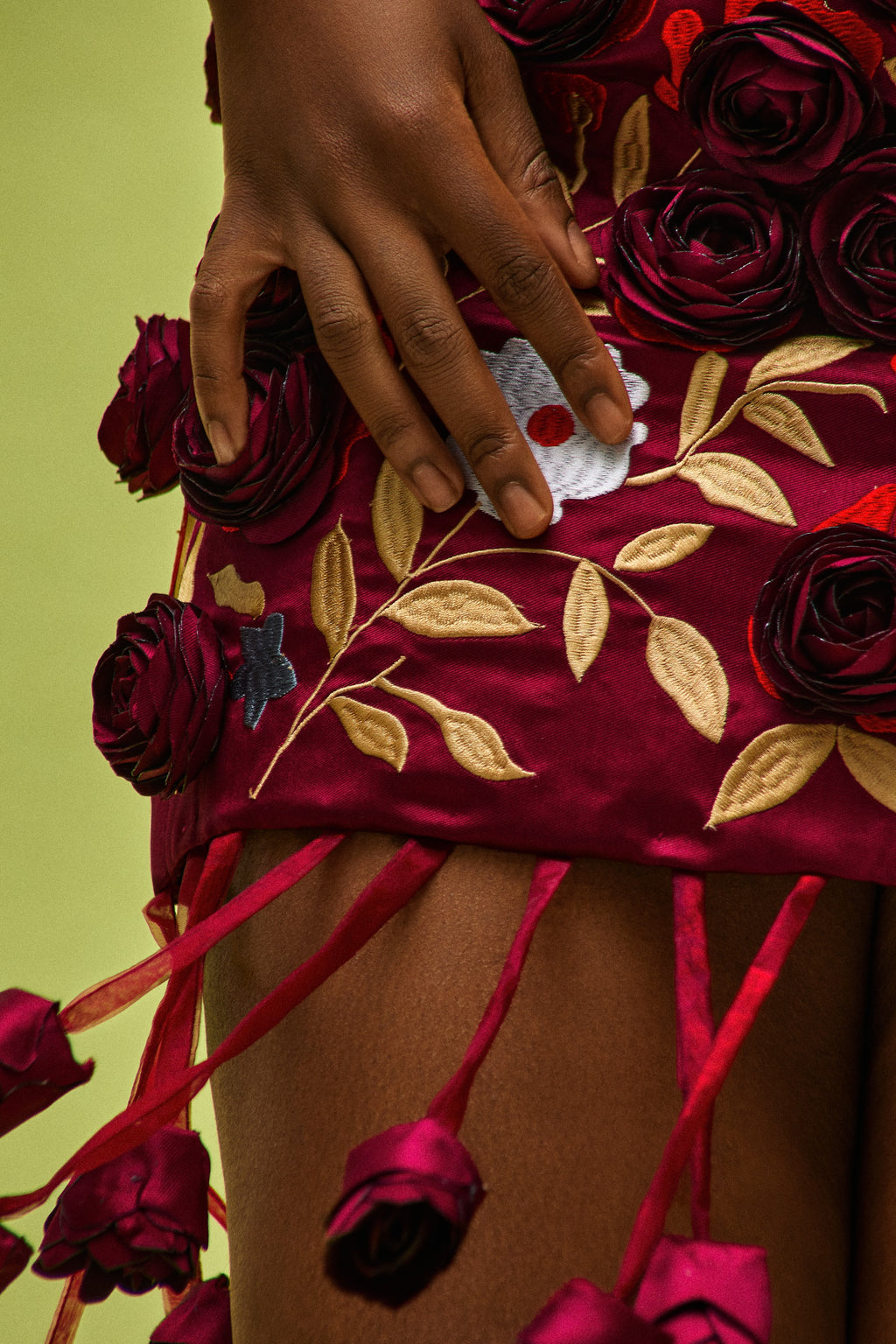 Close-up of hand-sculpted blooms and floral embroidery on the ÌGBÀANÌ Crimson Bloom Skirt